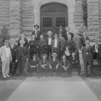 Men in front of Macky Auditorium photographs, undated: Photo 2