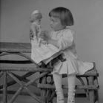 Noland child with doll and toy