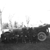 Police Department members beside a Buick at the Chautauqua auditorium