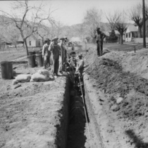 Laying pipe and filling ditch